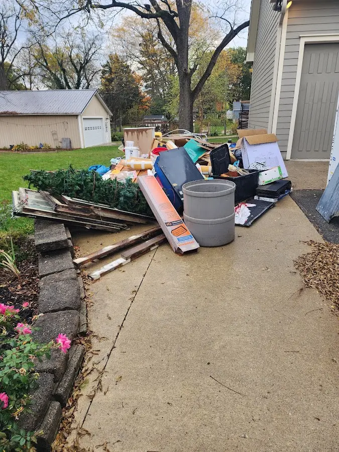 Dumpster being loaded with debris for 3 Yard Dumpster Rental in New Baltimore